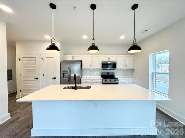 a kitchen with stainless steel appliances kitchen island a large island in the center