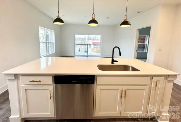 a kitchen with a sink cabinets and window
