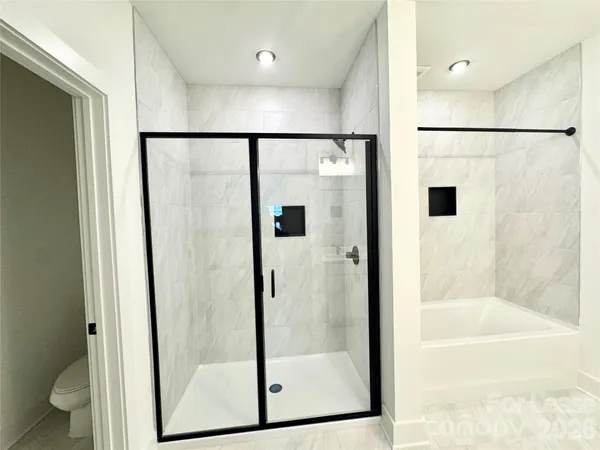 a bathroom with a glass shower door