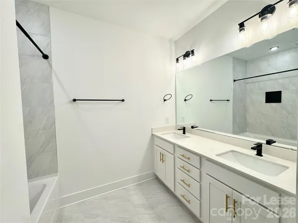 a bathroom with a double vanity sink and mirror