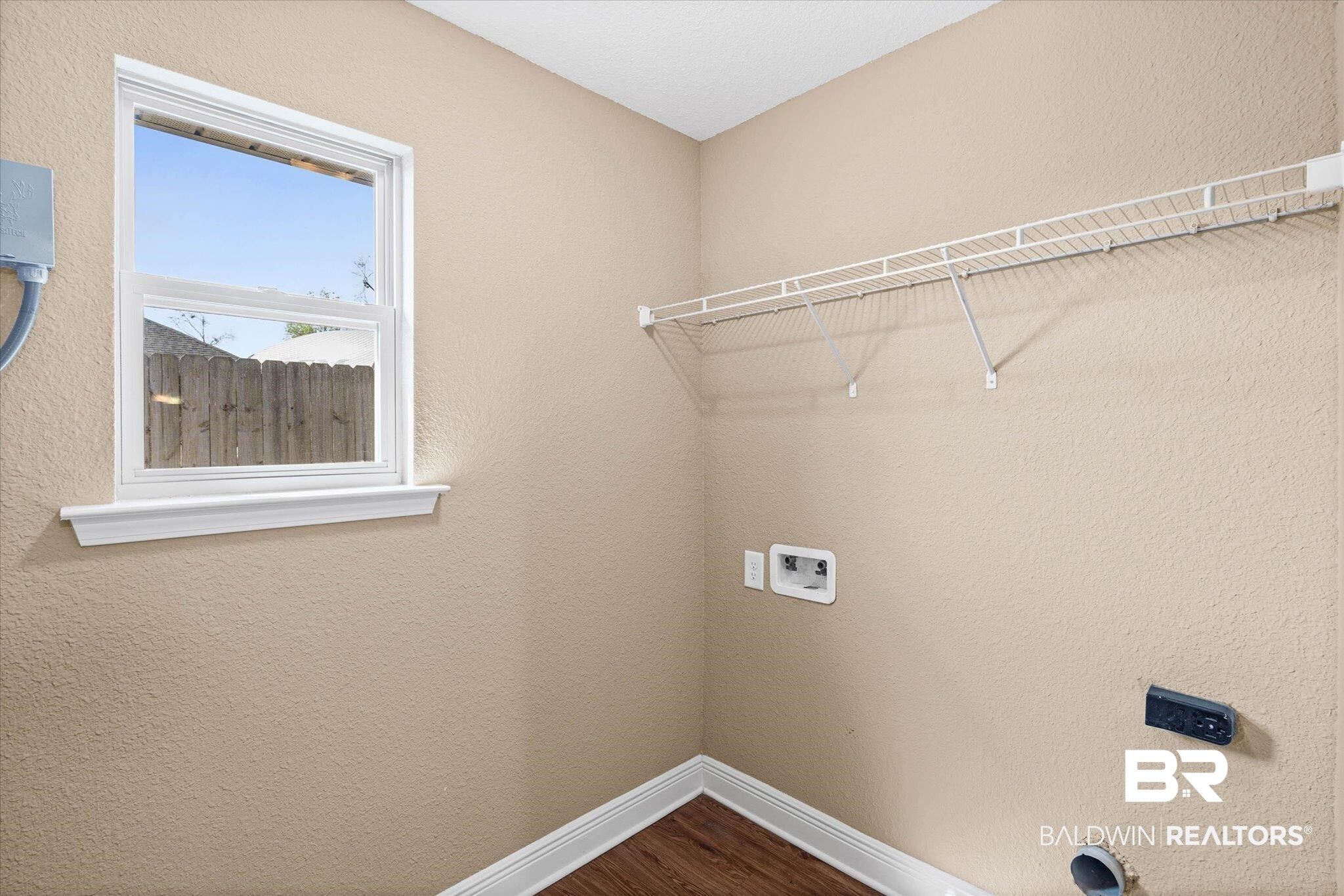 101 Washington Boulevard Foley, AL 36535 - Photo 22 of 32 Laundry room featuring a textured wall, dark wood-type flooring, and hookup for a washing machine