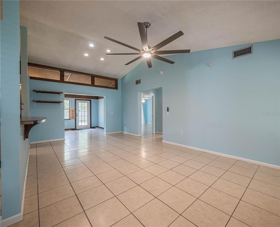4232 Stone Henge Road Mulberry, FL 33860 - Photo 3 of 12 a view of a livingroom with a ceiling fan and window