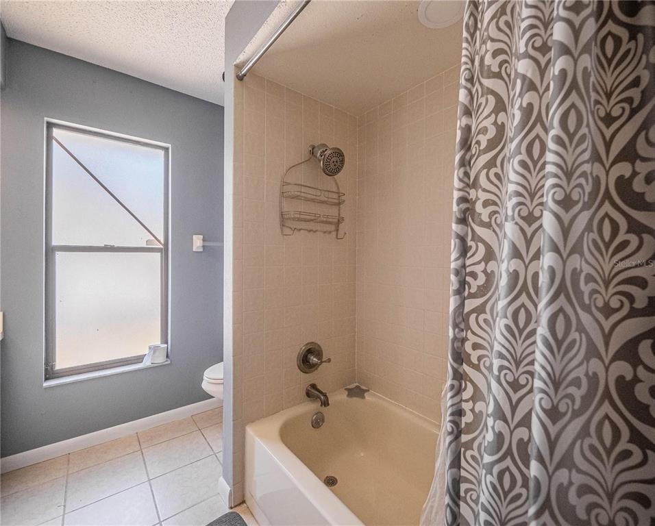 4232 Stone Henge Road Mulberry, FL 33860 - Photo 9 of 12 a bathroom with a bathtub and a shower