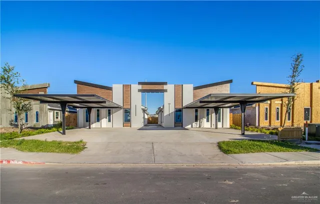 a front view of a residential apartment building with a yard