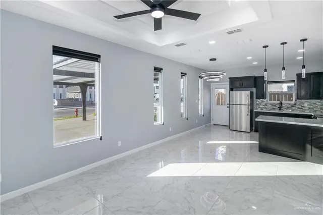 a large kitchen with stainless steel appliances kitchen island granite countertop a refrigerator oven a sink and dishwasher