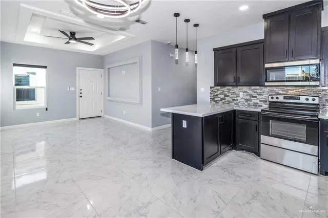 a kitchen with stainless steel appliances granite countertop a stove and a refrigerator