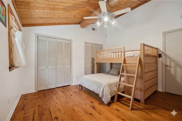 a bedroom with a bed and a ceiling fan