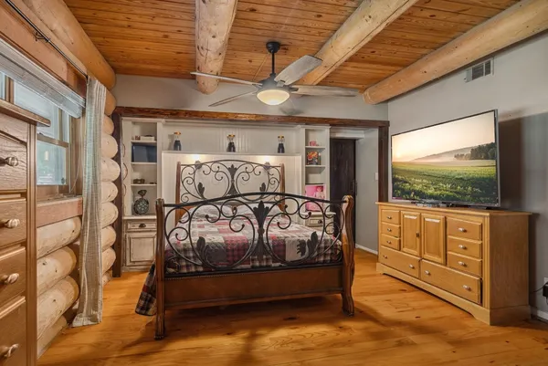 a bedroom with furniture and a flat screen tv