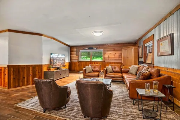 a living room with fireplace furniture and a large window