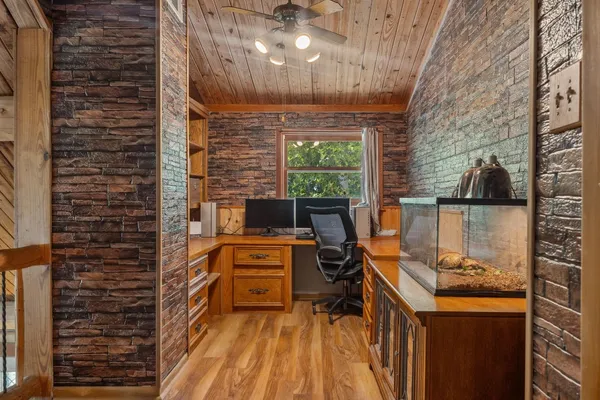 a view of a room with a fireplace and windows