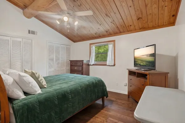 a bedroom with a bed and a flat screen tv