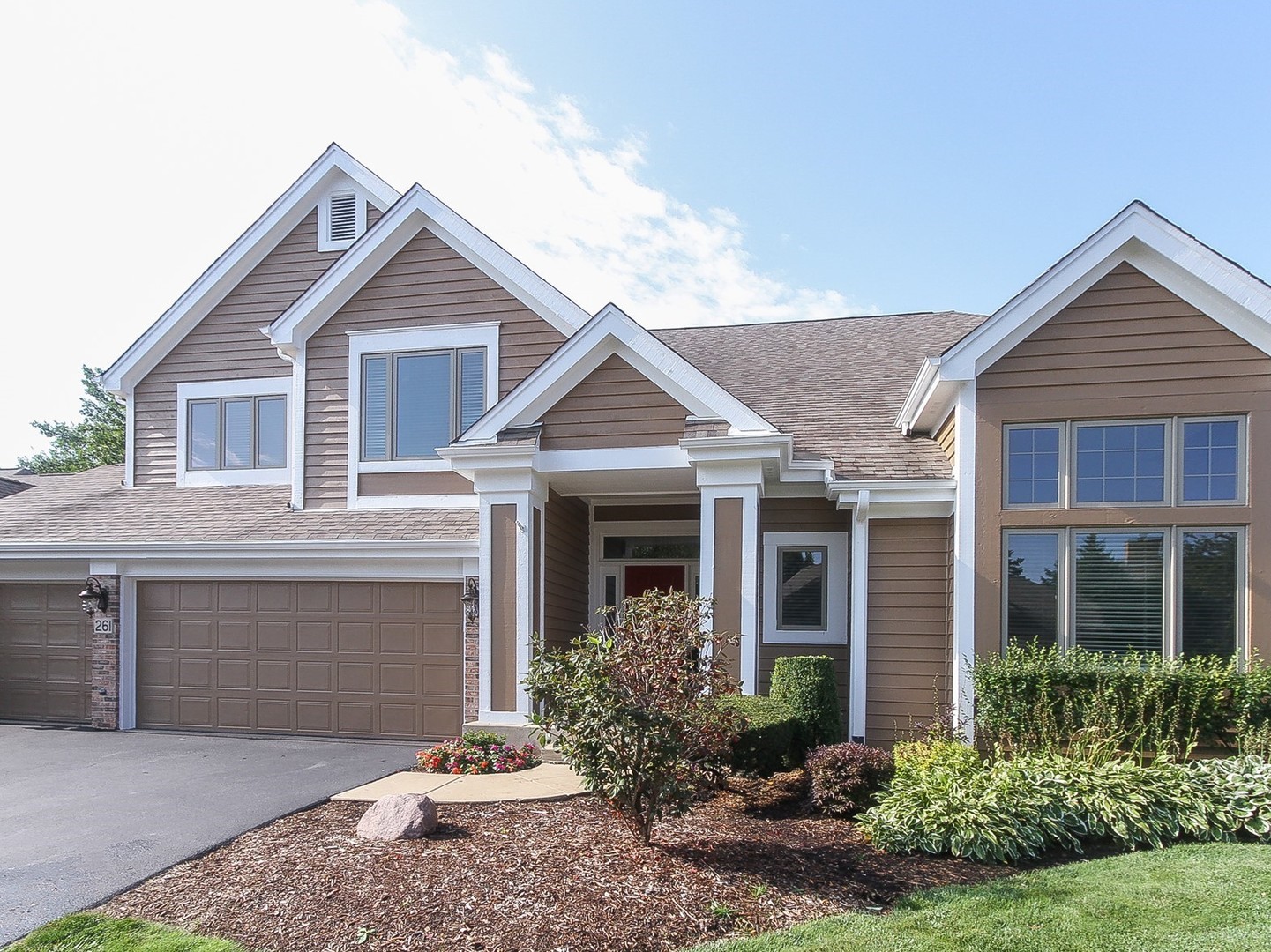 261 Course Drive Lake In The Hills, IL 60156 - Photo 2 of 35 a front view of a house with garden