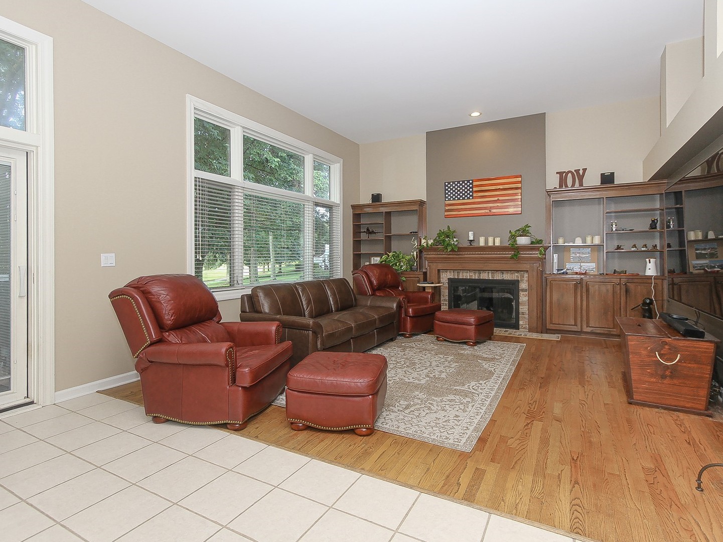 261 Course Drive Lake In The Hills, IL 60156 - Photo 10 of 35 a living room with furniture a fireplace and a flat screen tv