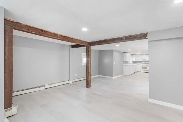 an empty room with a ceiling fan and windows