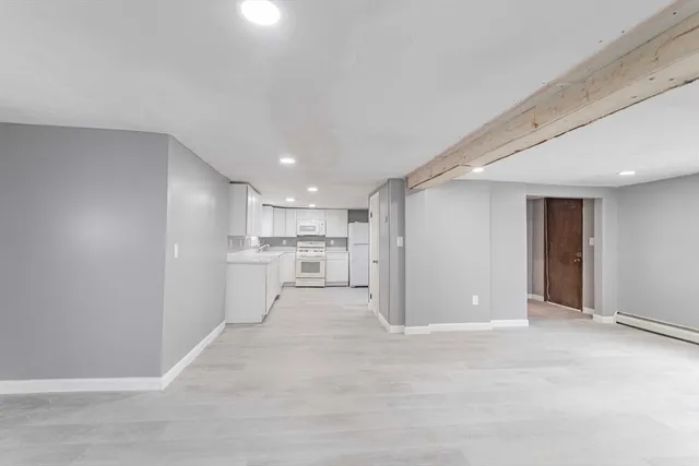 a view of a kitchen with white cabinets