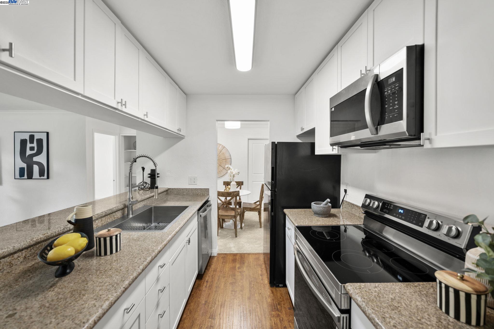 1085 Murrieta Boulevard, Unit 222 Livermore, CA 94550 - Photo 1 of 25 a kitchen with a sink a counter and cabinets