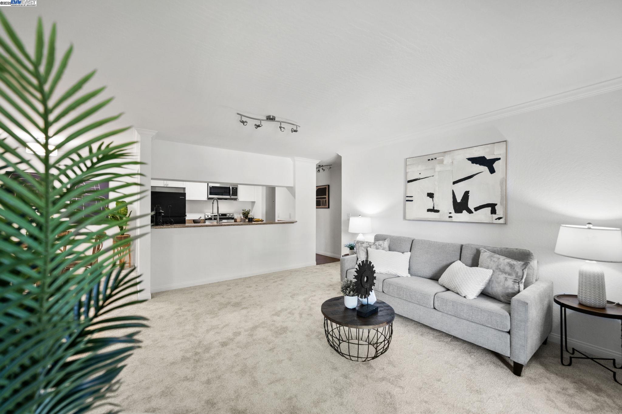 1085 Murrieta Boulevard, Unit 222 Livermore, CA 94550 - Photo 13 of 25 a living room with furniture and a potted plant