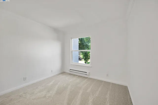 an empty room with closet and a bathroom