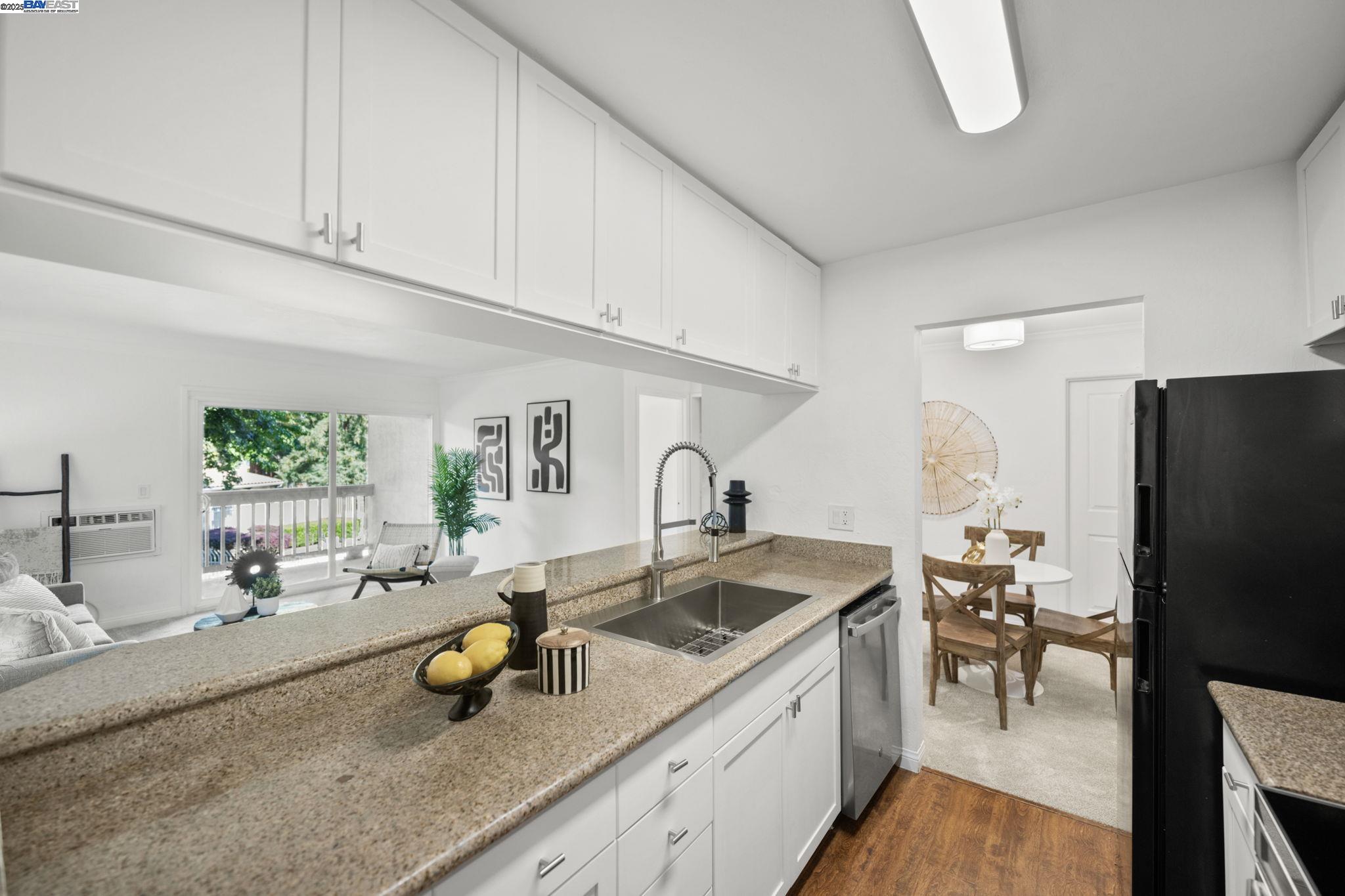 1085 Murrieta Boulevard, Unit 222 Livermore, CA 94550 - Photo 3 of 25 a kitchen with a sink a counter and chairs