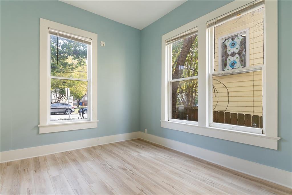 3210 Hampton Road, Unit A B C Austin, TX 78705 - Photo 26 of 42 Bright interior space featuring light blue walls and wood-finish flooring