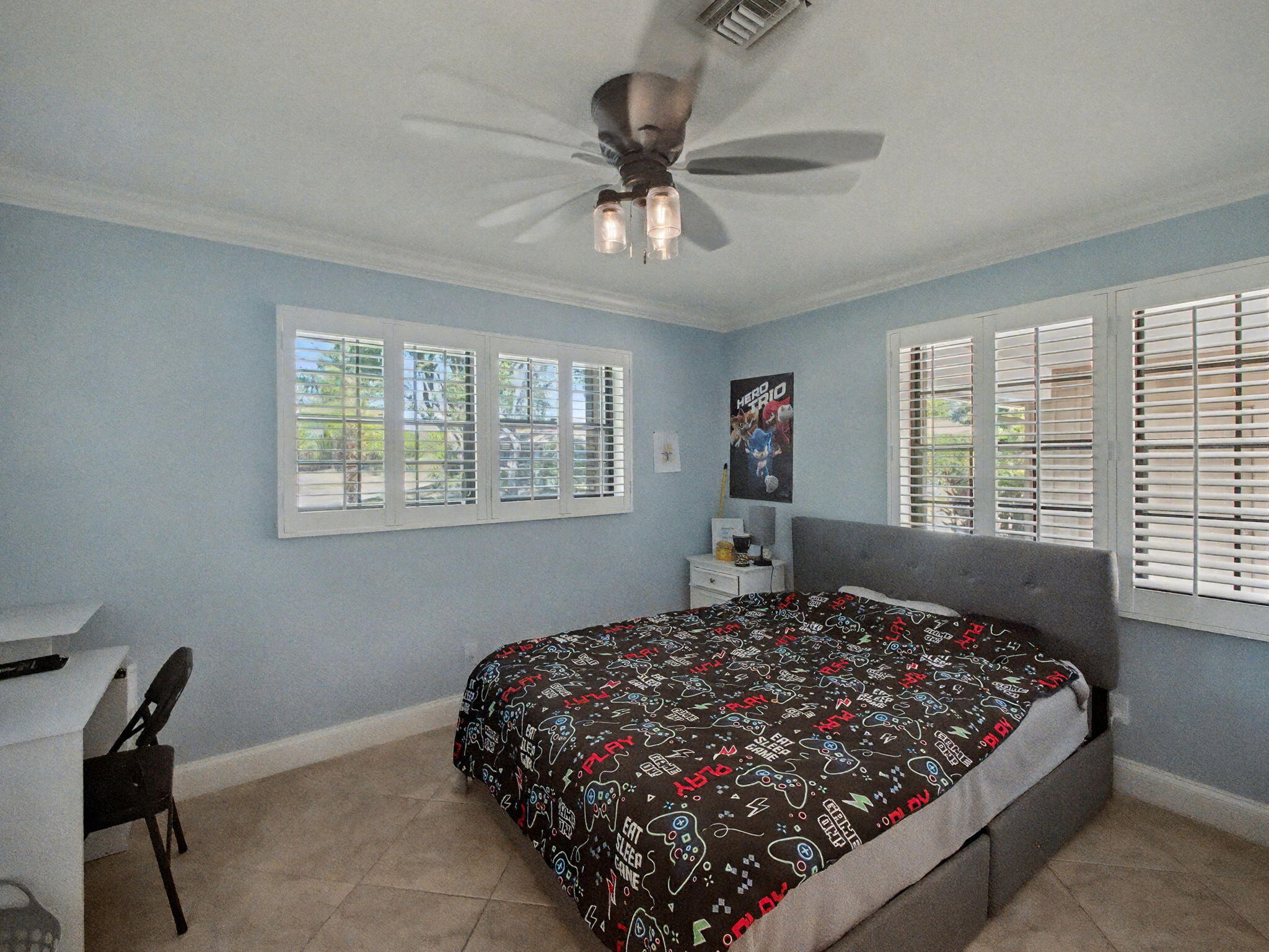 720 Muirfield Circle Atlantis, FL 33462 - Photo 12 of 20 a bed sitting in a bedroom next to a window
