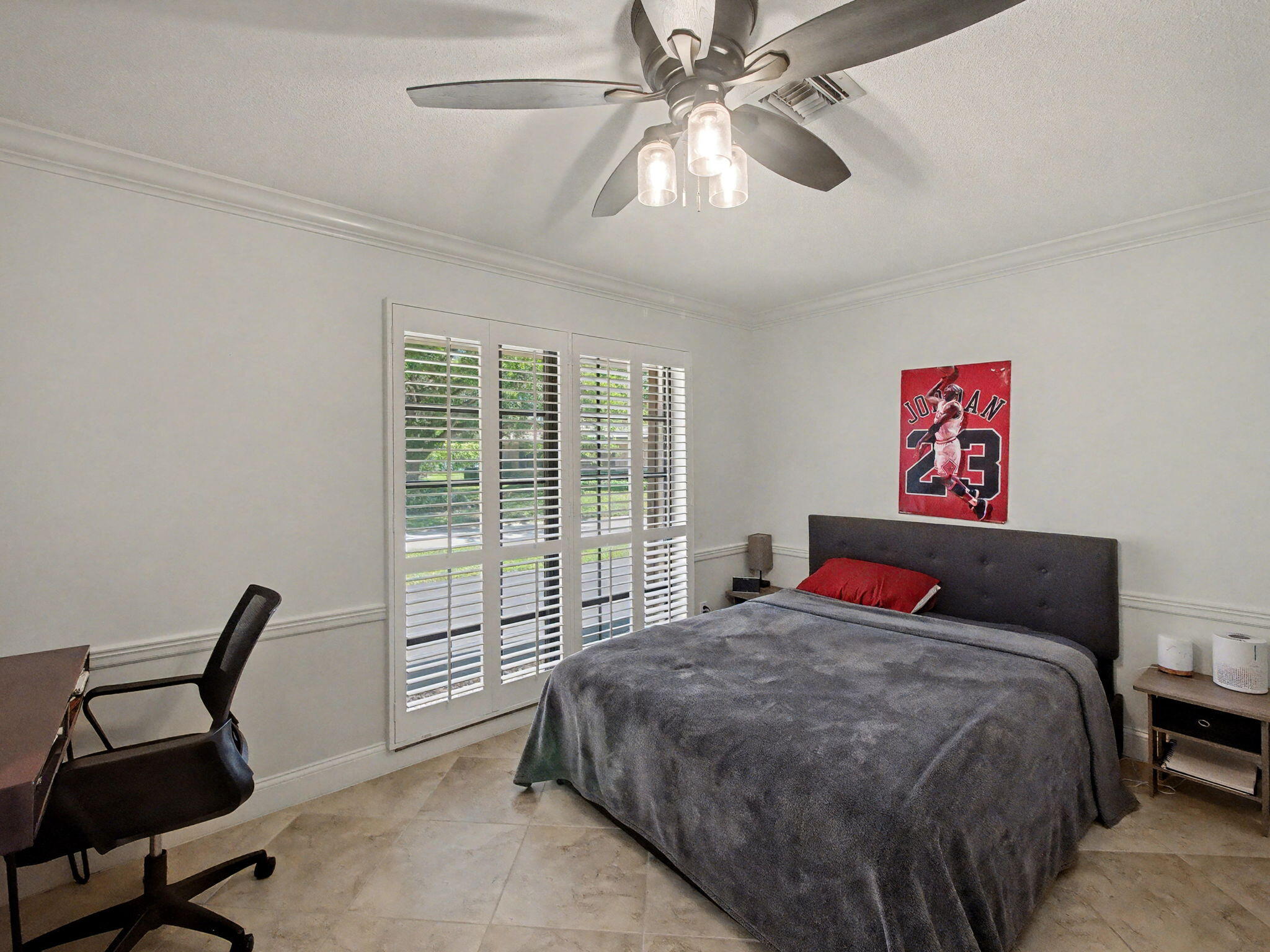 720 Muirfield Circle Atlantis, FL 33462 - Photo 14 of 20 a bedroom with a bed and a chair