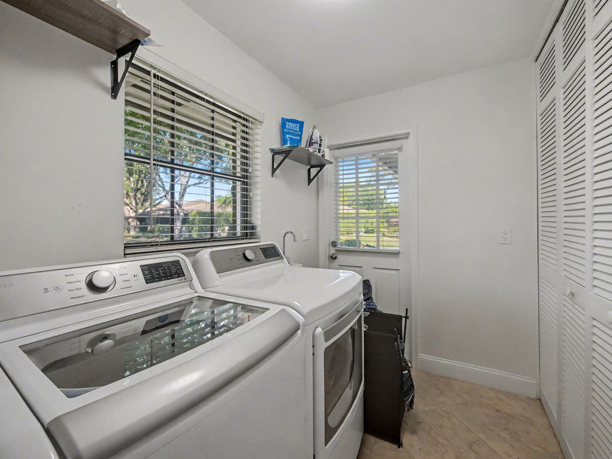 720 Muirfield Circle Atlantis, FL 33462 - Photo 15 of 20 a utility room with dryer and washer