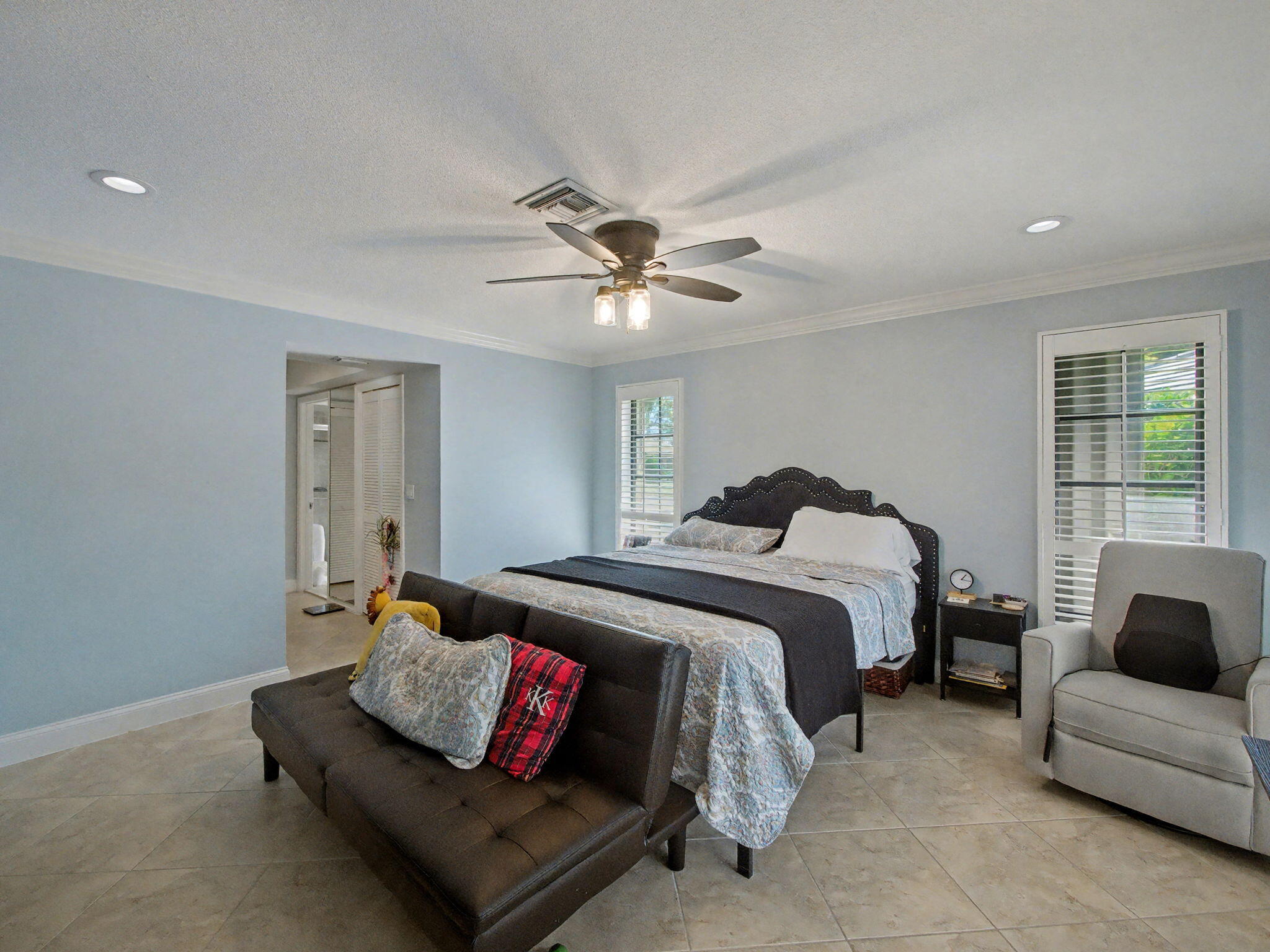 720 Muirfield Circle Atlantis, FL 33462 - Photo 17 of 20 a spacious bedroom with a bed and window