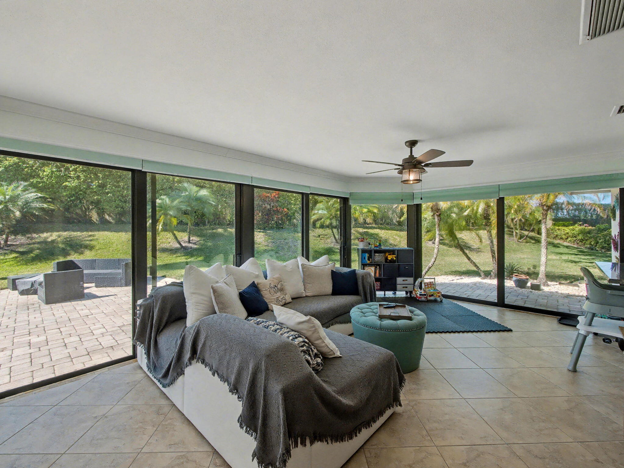 720 Muirfield Circle Atlantis, FL 33462 - Photo 4 of 20 a living room with furniture and large windows