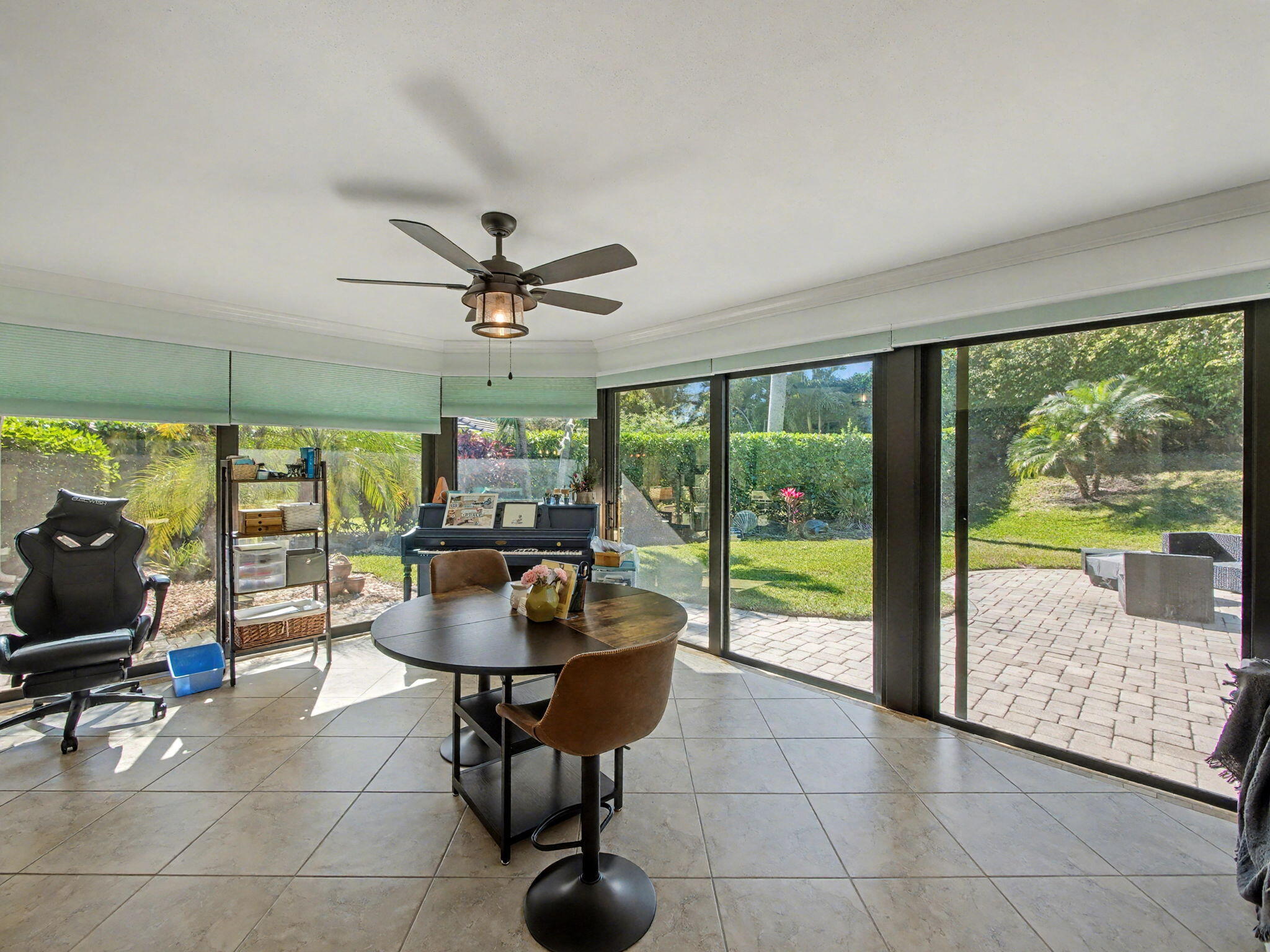 720 Muirfield Circle Atlantis, FL 33462 - Photo 5 of 20 a living room with couches and a dining table with garden view