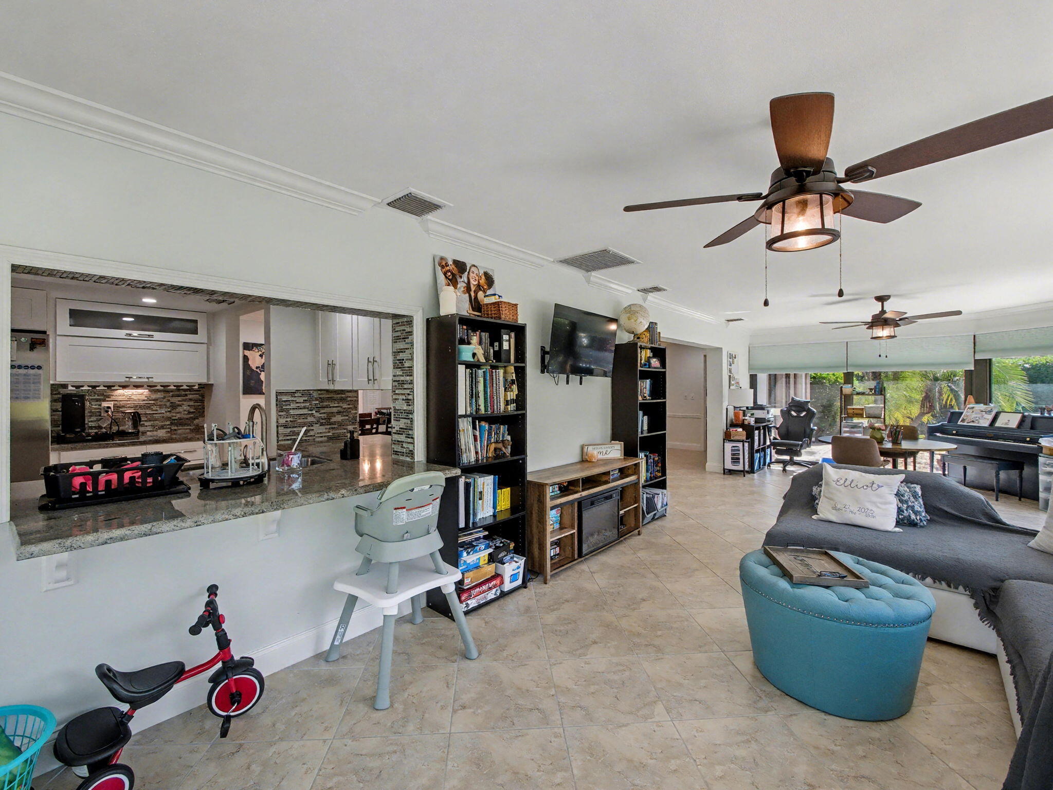720 Muirfield Circle Atlantis, FL 33462 - Photo 7 of 20 a living room with lots of furniture and gym equipment