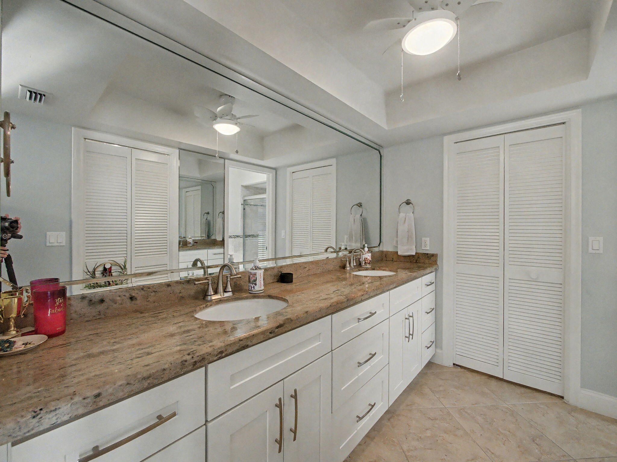 720 Muirfield Circle Atlantis, FL 33462 - Photo 9 of 20 a bathroom with double sink and a mirror