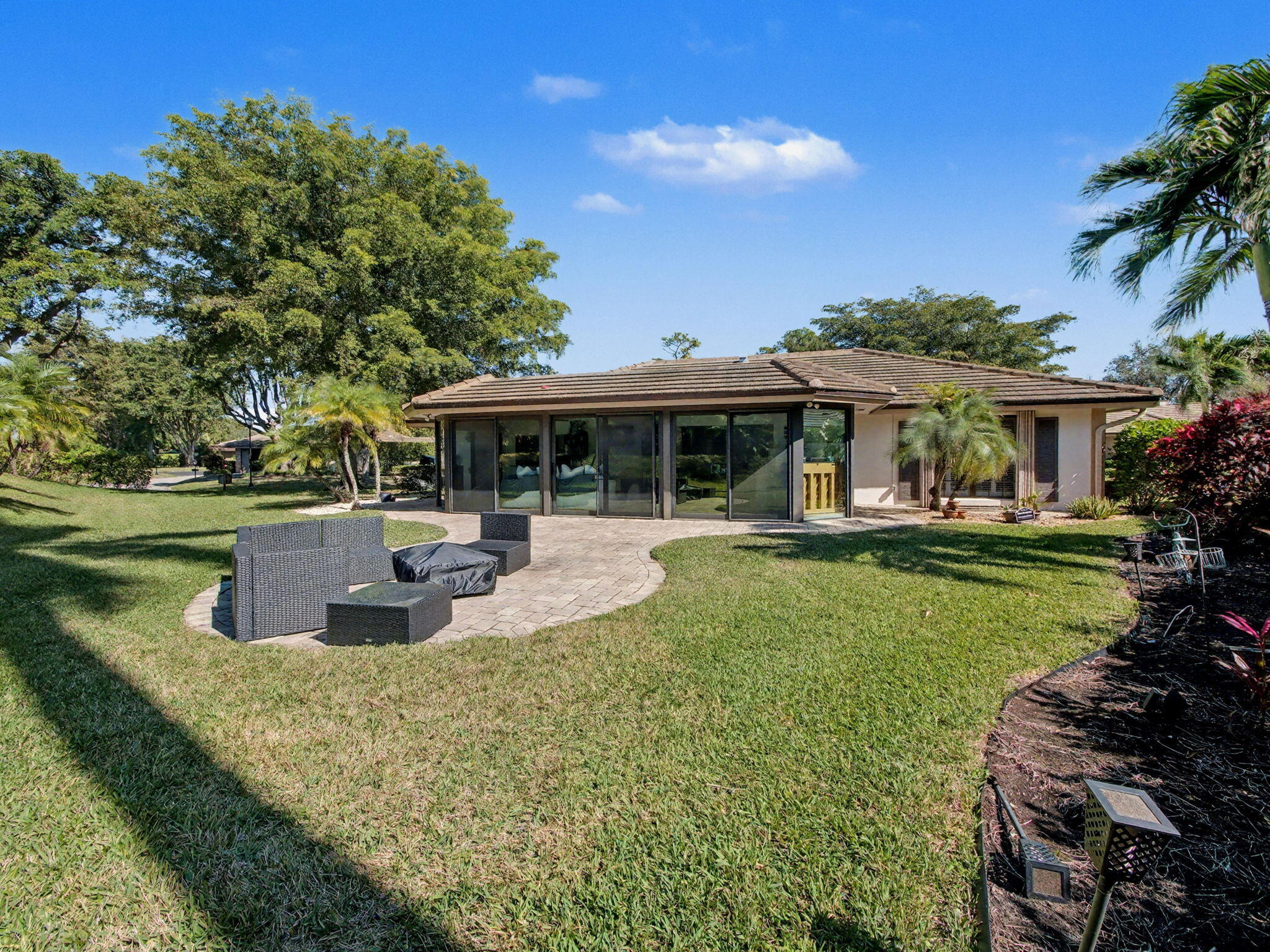 720 Muirfield Circle Atlantis, FL 33462 - Photo 10 of 20 a view of a house with swimming pool and sitting area