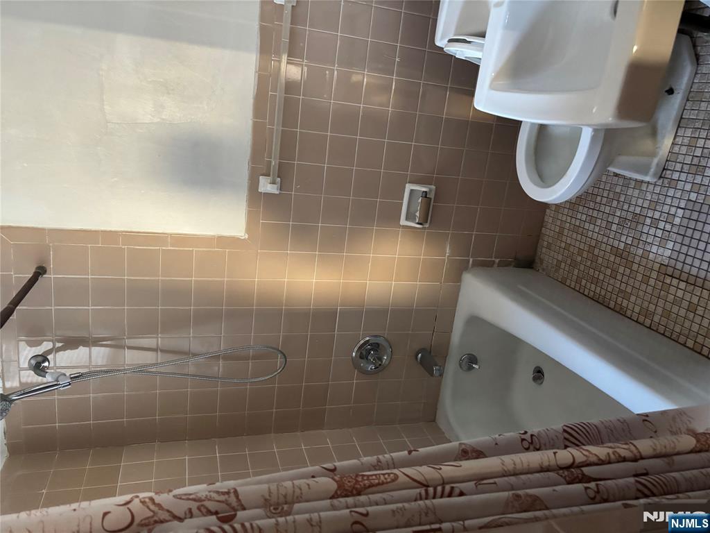 86 Center Street, Unit 2R Clifton, NJ 07011 - Photo 4 of 8 a bathroom with a sink and toilet