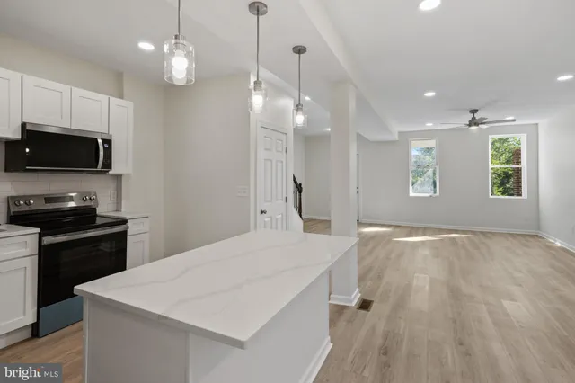 a kitchen with a stove a sink and a refrigerator
