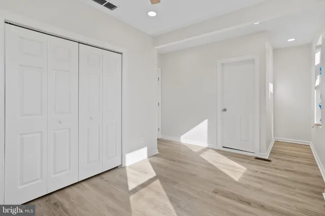 an empty room with wooden floor