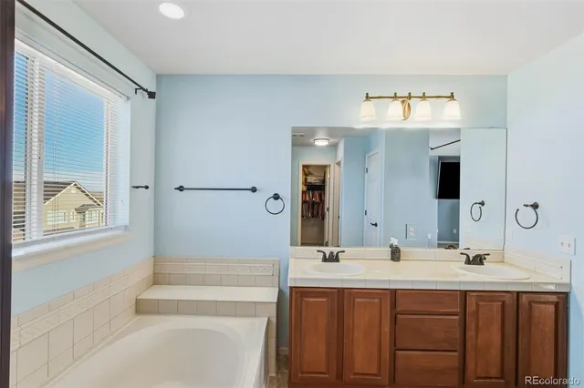 a white bath tub sitting next to a white sink