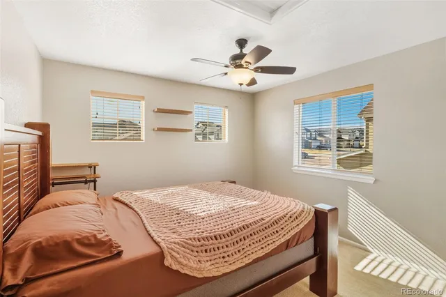 a bedroom with a bed and ceiling fan