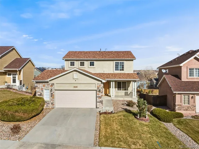 a front view of a house with a yard