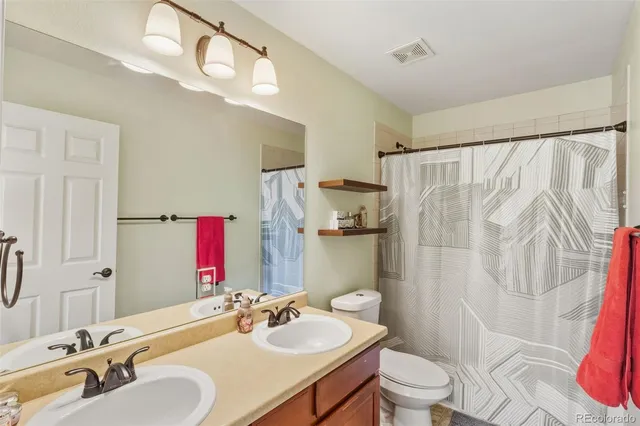 a utility room with dryer washer and a view of living room