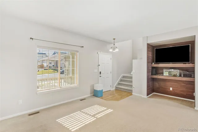 a bedroom with a bed and a television