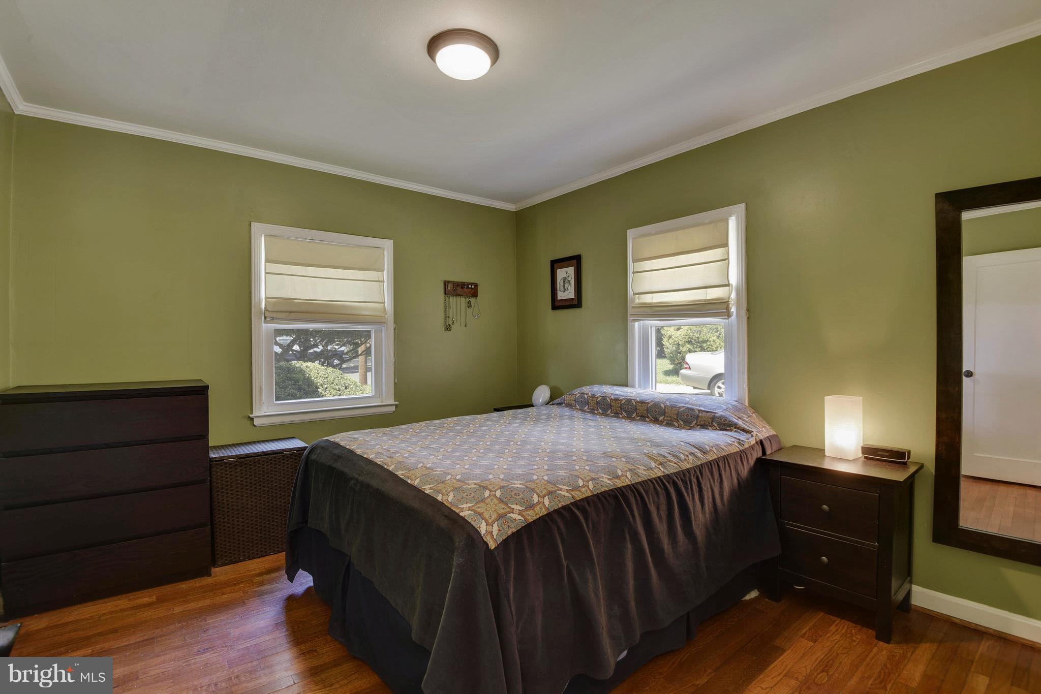 4412 Bennion Road Silver Spring, MD 20906 - Photo 17 of 29 a bedroom with a bed and wooden floor