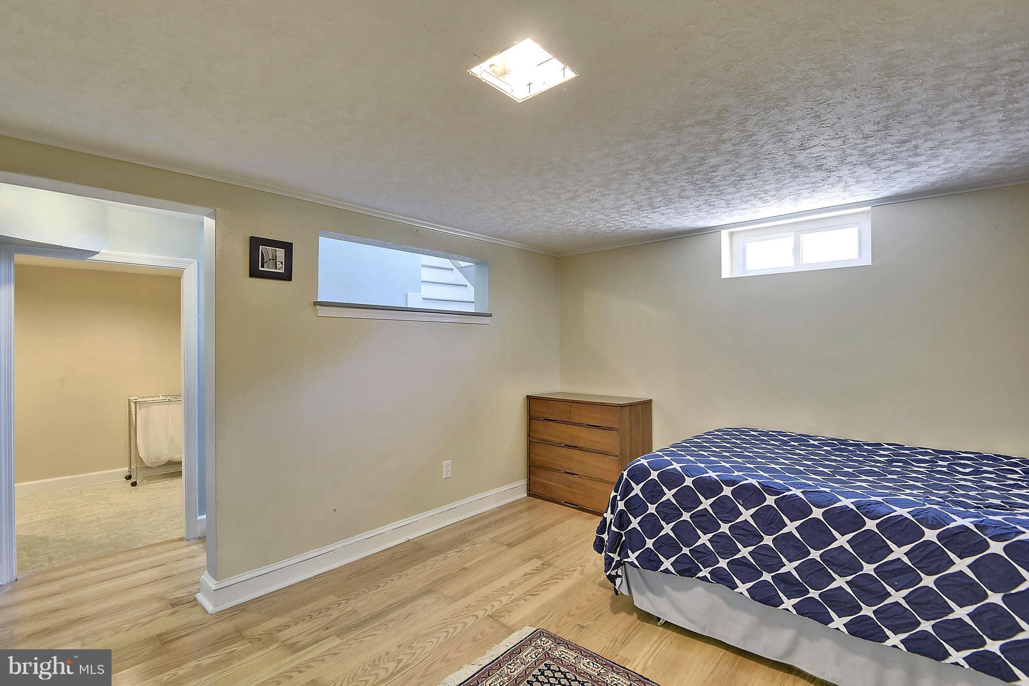 4412 Bennion Road Silver Spring, MD 20906 - Photo 21 of 29 a bedroom with a bed and wooden floor