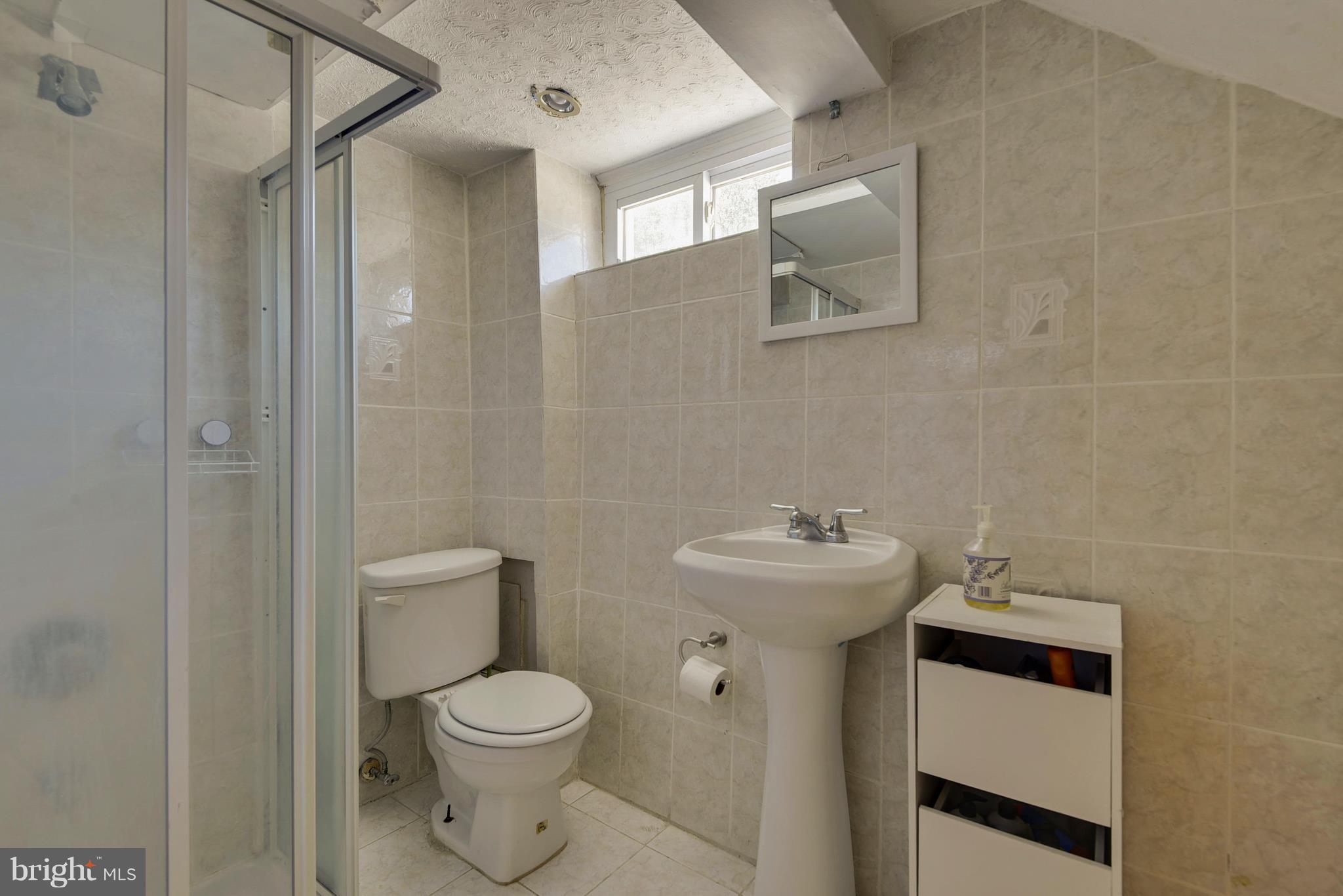 4412 Bennion Road Silver Spring, MD 20906 - Photo 24 of 29 a bathroom with a toilet sink and mirror