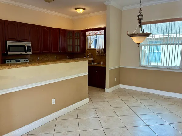 an empty room with windows and furniture