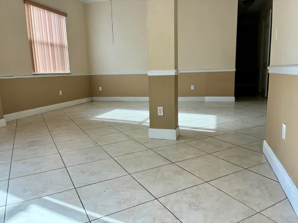 a view of a livingroom with an empty space and window