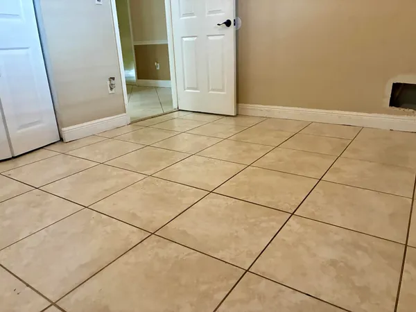 a view of a livingroom with an empty space and a window