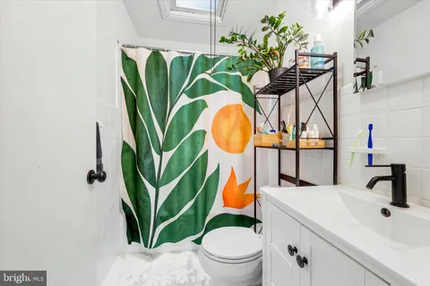 a bathroom with a sink mirror and toilet
