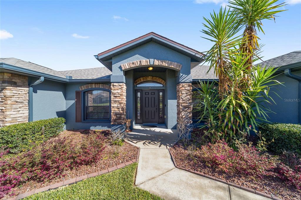 4037 Southeast 40th Street Ocala, FL 34480 - Photo 1 of 38 a front view of a house with a yard