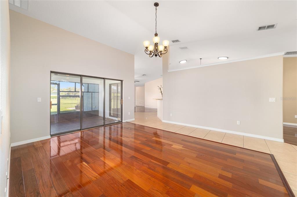 4037 Southeast 40th Street Ocala, FL 34480 - Photo 14 of 38 a view of an empty room with wooden floor and a window